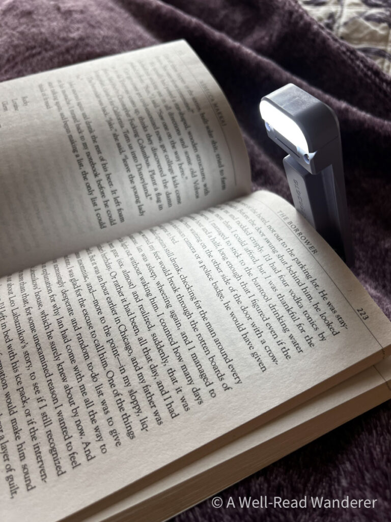 book light clipped on back of book shining light on the page