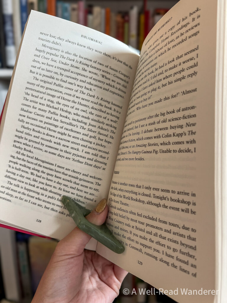 book page holder on thumb holding open hardcover book