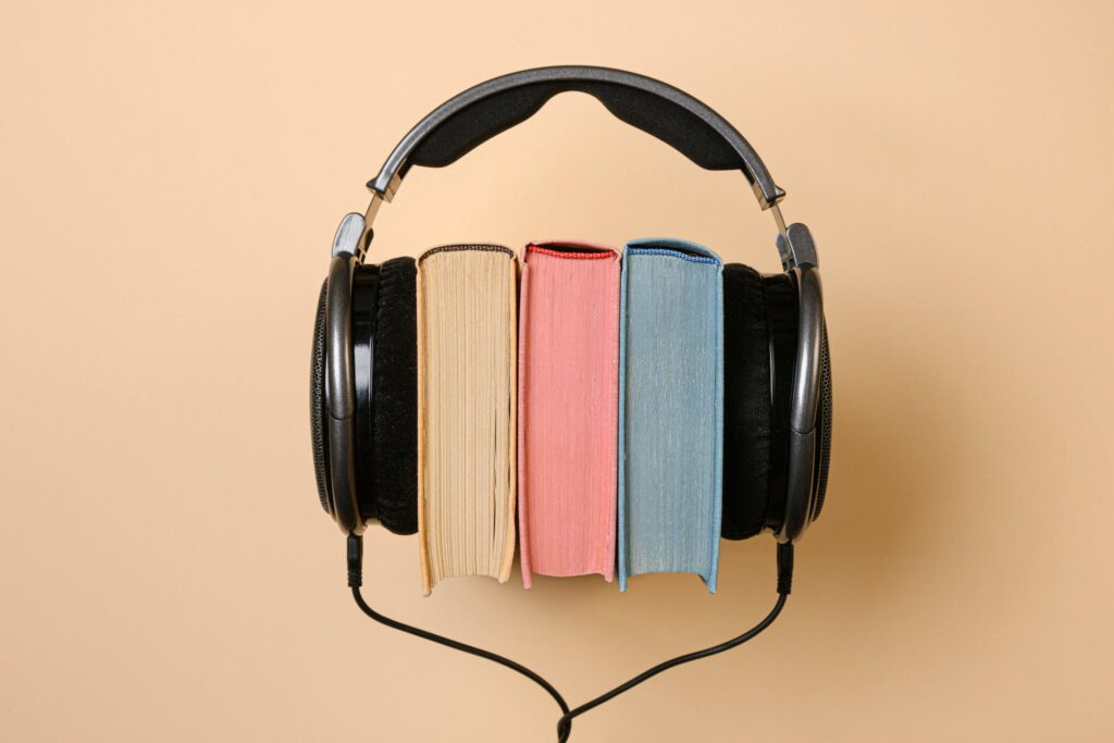 colorful books with black headphones around them