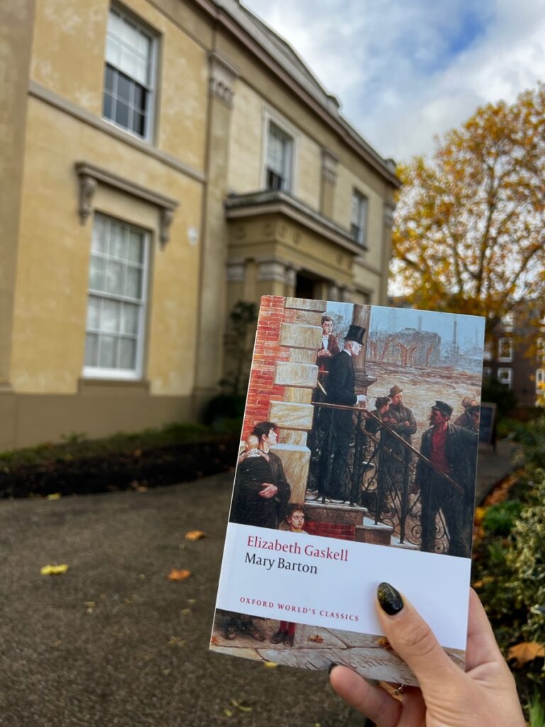 novel mary barton by elizabeth gaskell held in front of elizabeth gaskells house in manchester england
