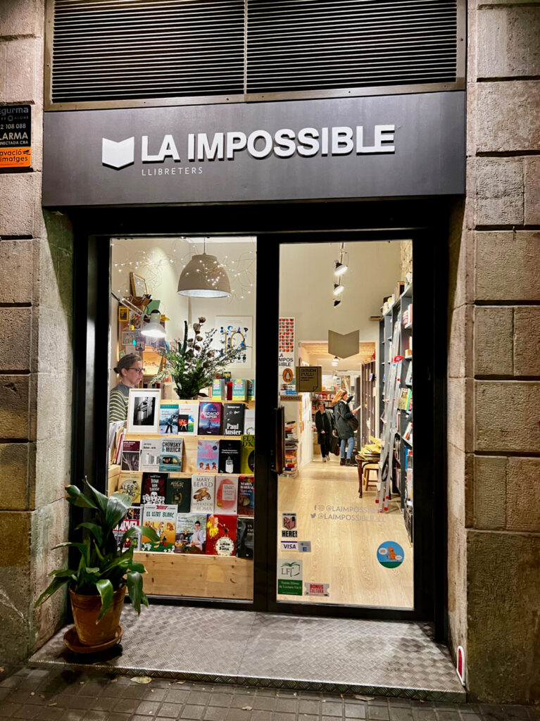 la impossible a bookshop in barcelona, exterior with shop sign and view inside of bookshelves