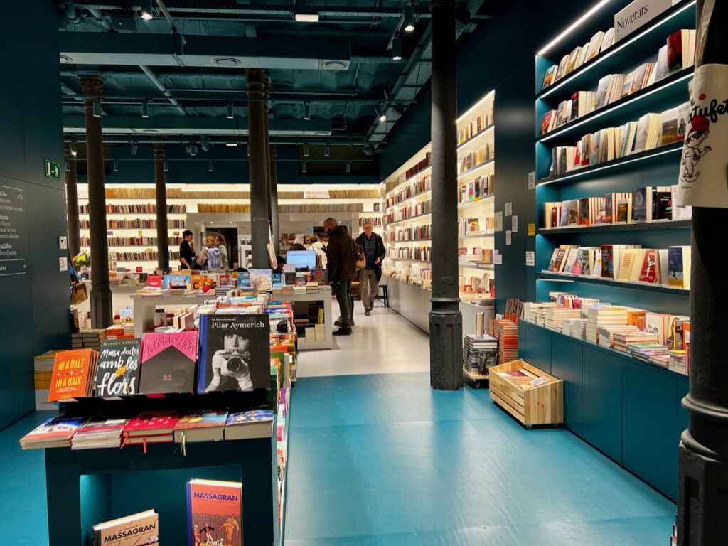 llibreria ona a catalan bookshop in Barcelona, modern backlit bookshelves line the walls of a bookstore