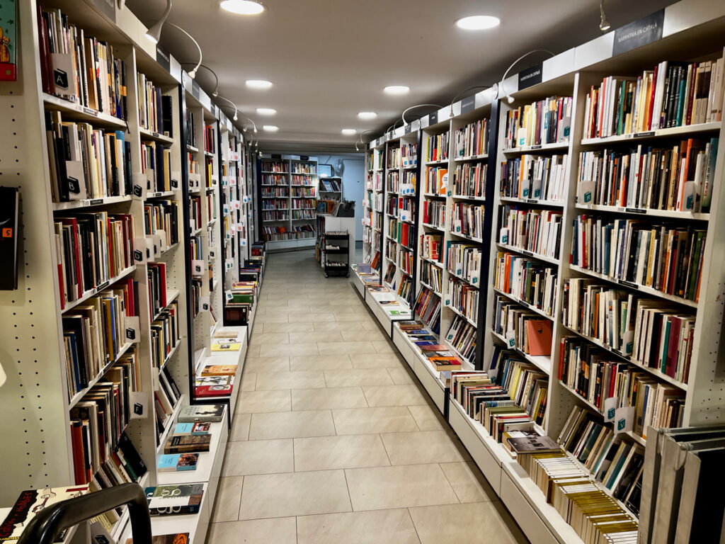 re-read is a chain of used bookstores in barcelona and includes english books. bookshelves line both walls of a hallway