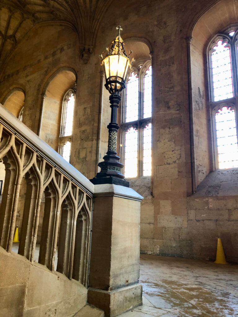 hogwarts hallway staircase at oxford university harry potter filming location, gothic stone staircase with lamp