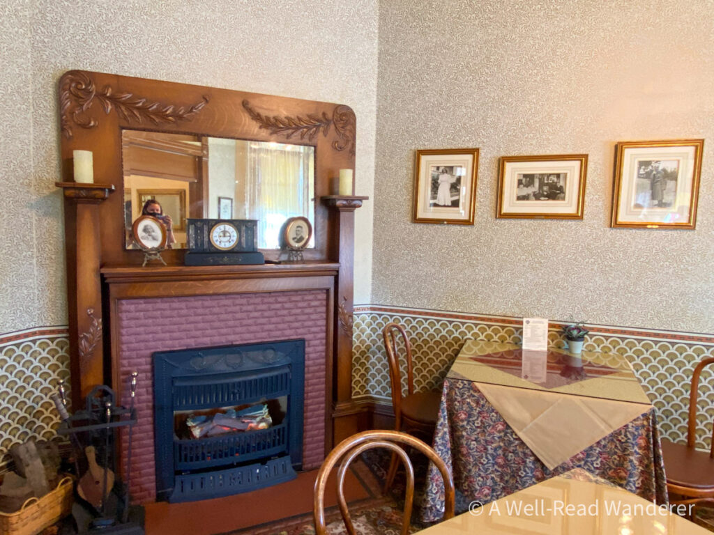 steinbeck dining room with fireplace and mirror over mantle
