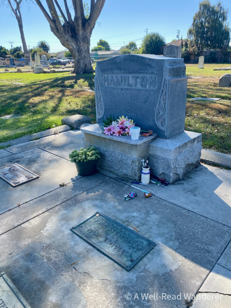 where john steinbeck is buried, a family plot with a john steinbeck tomb stone and flowers and moments on top