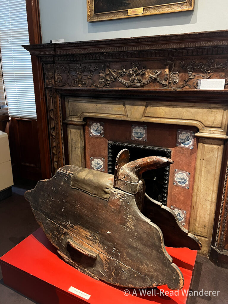 antique wooden rocking horse in front of a fireplace