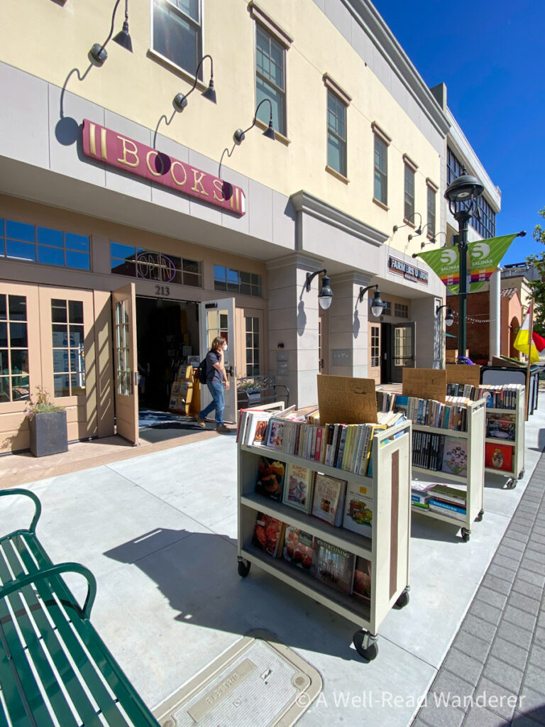 exterior of a bookstore with book carts on the sidewalk on a sunny day in downtown salinas