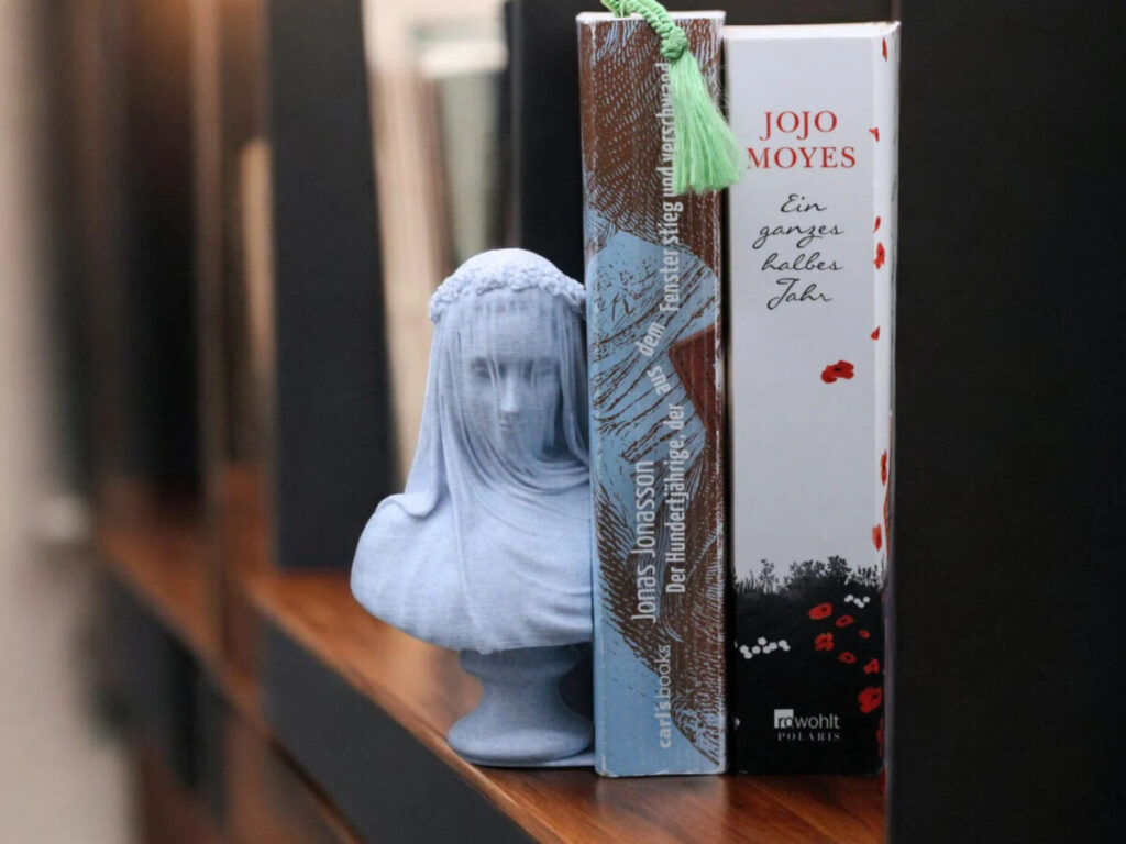 bookend statue of veiled woman's head