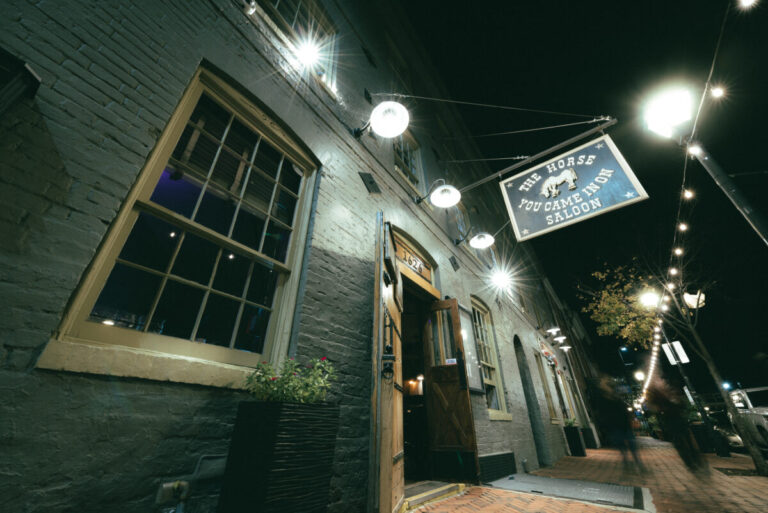exterior of green tavern with hanging sign reading the horse you came in on saloon in baltimore maryland