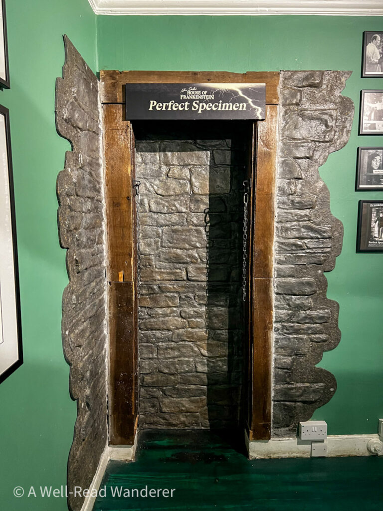 photo spot inside mary shelley museum house of frankenstein in bath to look like a chained creature with green and brick walls
