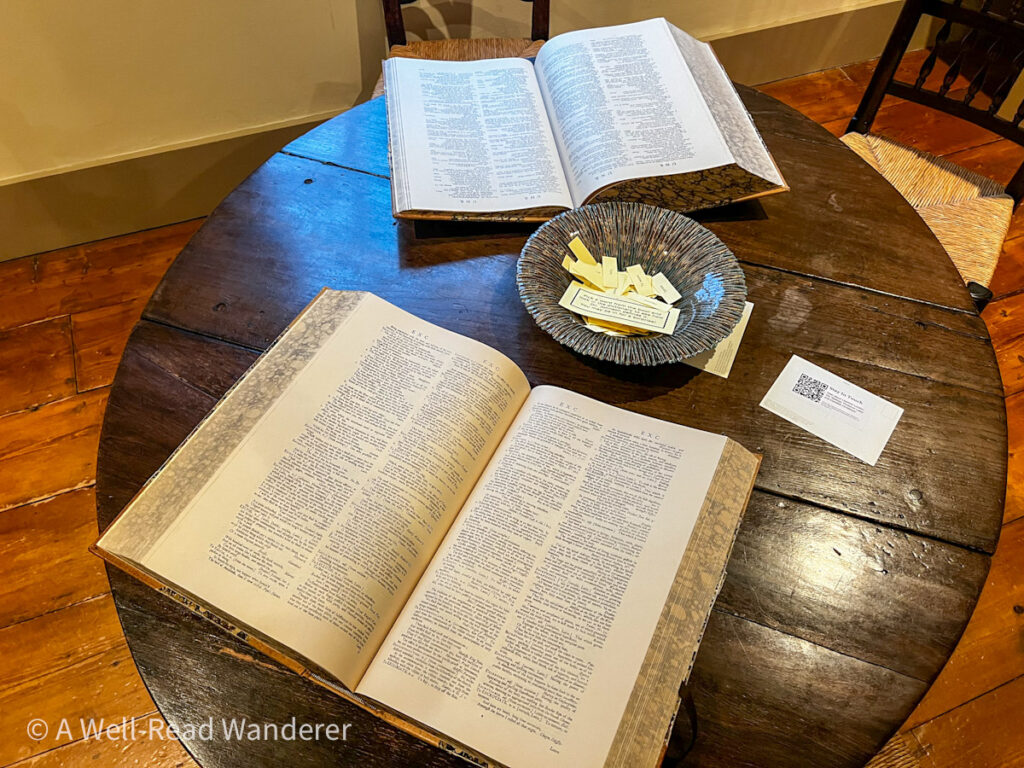 open replicas of first edition of samuel johnson's dictionary of the english language open on a dark wooden table