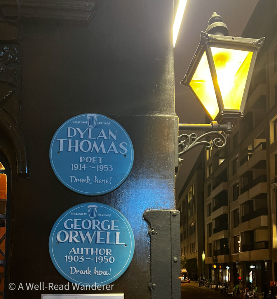 blue plaques outside a historic london pub indicating dylan thomas and george orwell drank there
