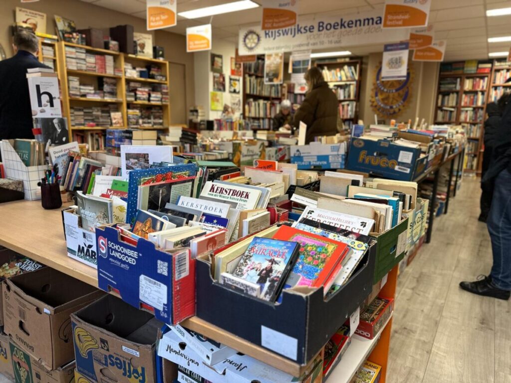 rijswijkse boekenmarkt book market in the hague with tables and bins full of books and people browsing